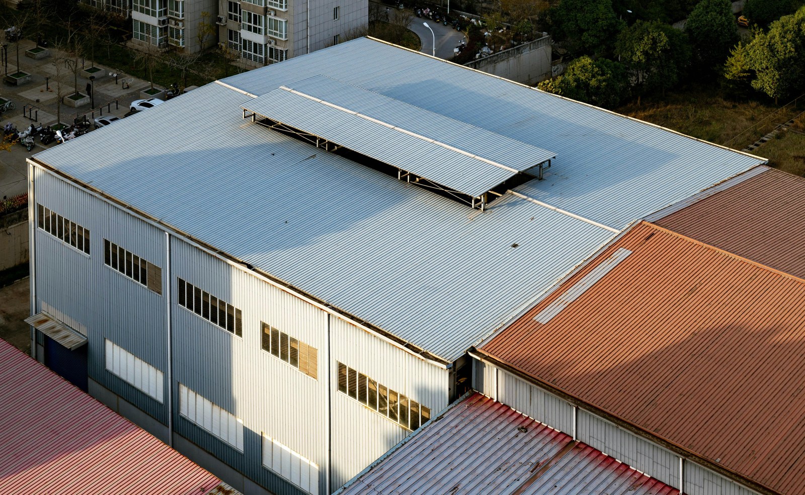 Elevated view of silver and rust-brown industrial metal roofs